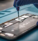 A closeup shot of a specialist repairing a mobile phone